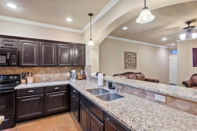 kitchen featuring pendant lighting, sink, black appliances, crown molding, and dark brown cabinetry