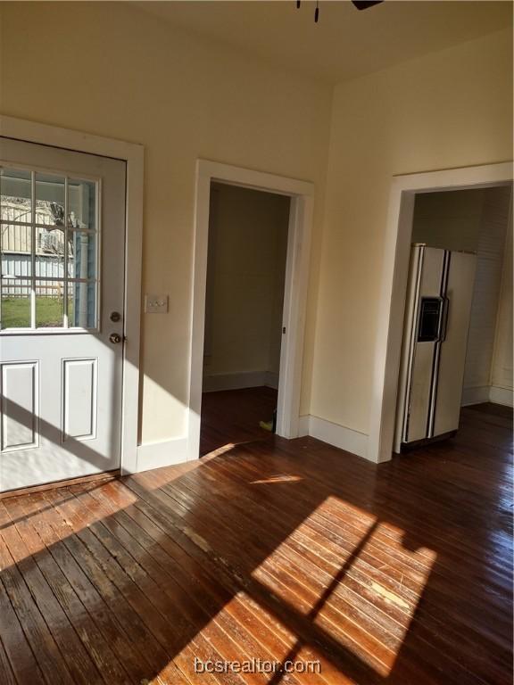 unfurnished room with ceiling fan and dark hardwood / wood-style floors