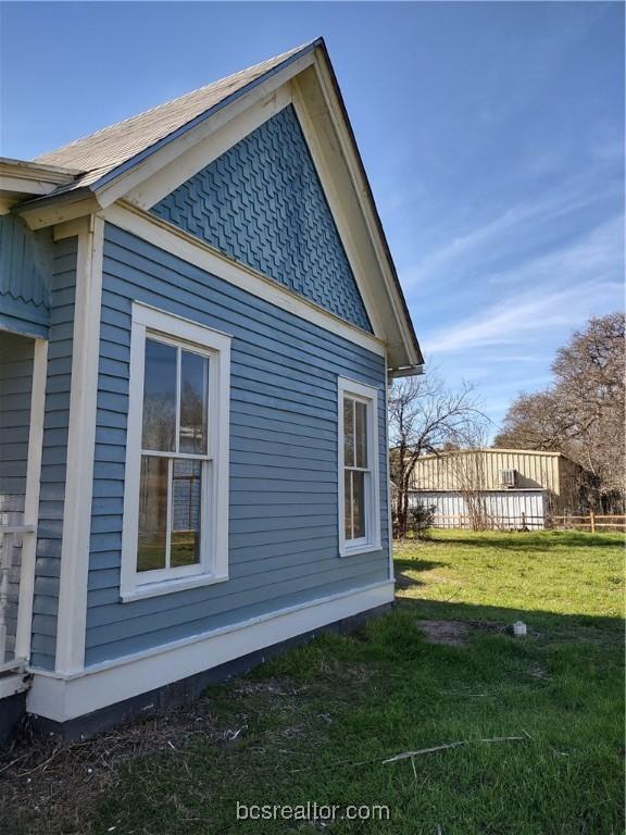 view of side of home featuring a lawn