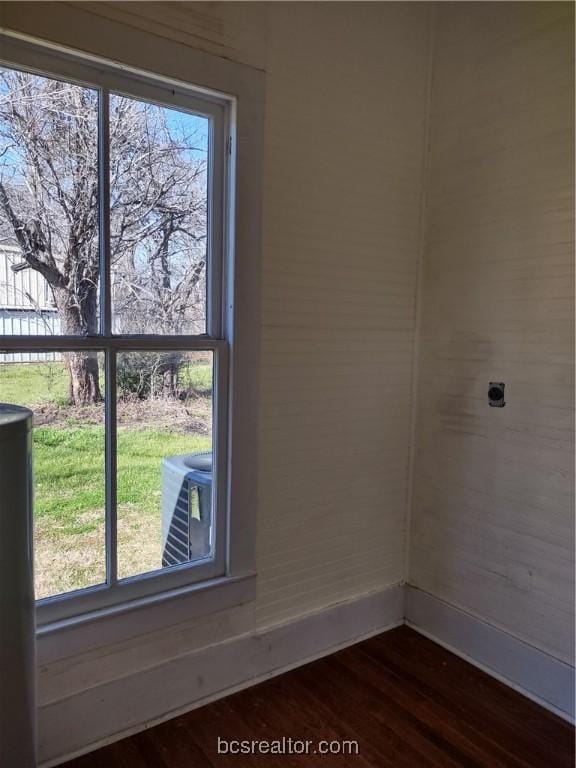 unfurnished room featuring dark wood-type flooring