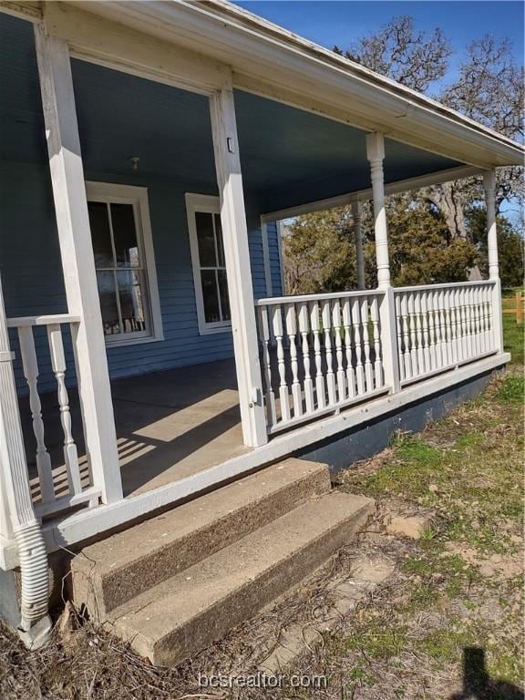 view of side of home with covered porch