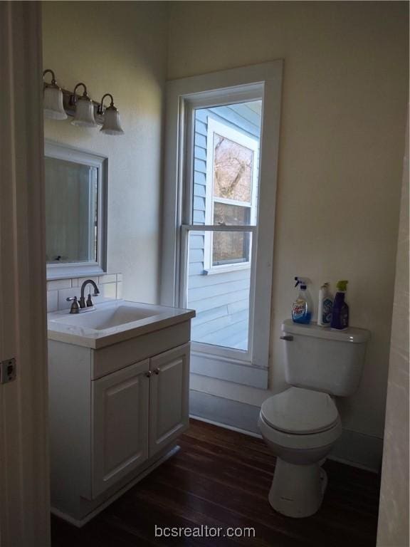 bathroom featuring hardwood / wood-style flooring, vanity, and toilet