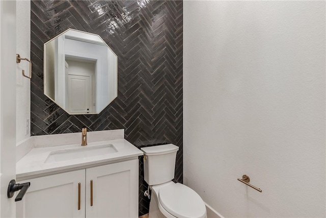 bathroom with tasteful backsplash, vanity, tile walls, and toilet