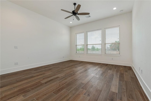 empty room featuring ceiling fan and dark hardwood / wood-style floors