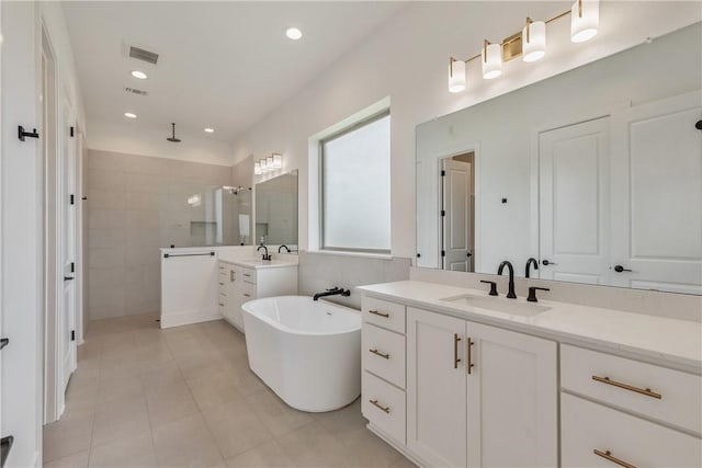 bathroom featuring vanity, tile patterned flooring, and plus walk in shower