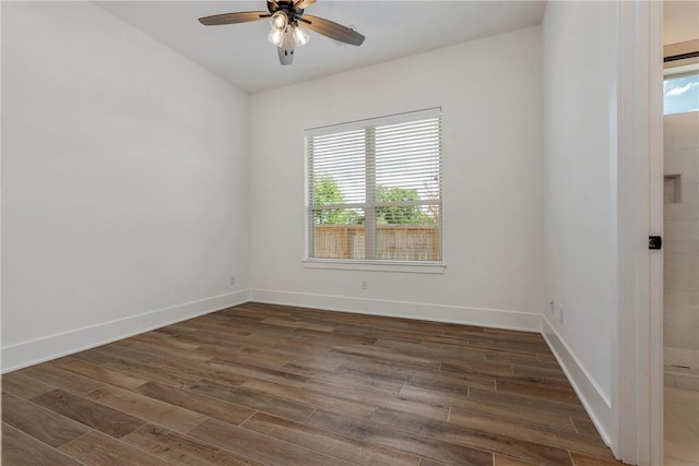 spare room with ceiling fan and dark hardwood / wood-style flooring