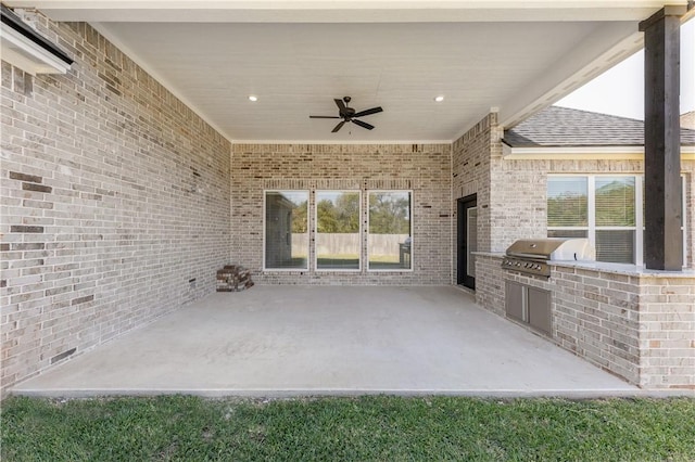 view of patio with a grill, ceiling fan, and an outdoor kitchen