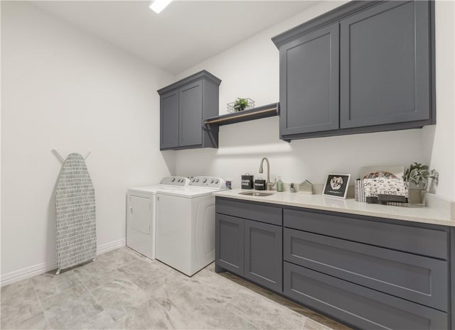 laundry room with sink, cabinets, and independent washer and dryer