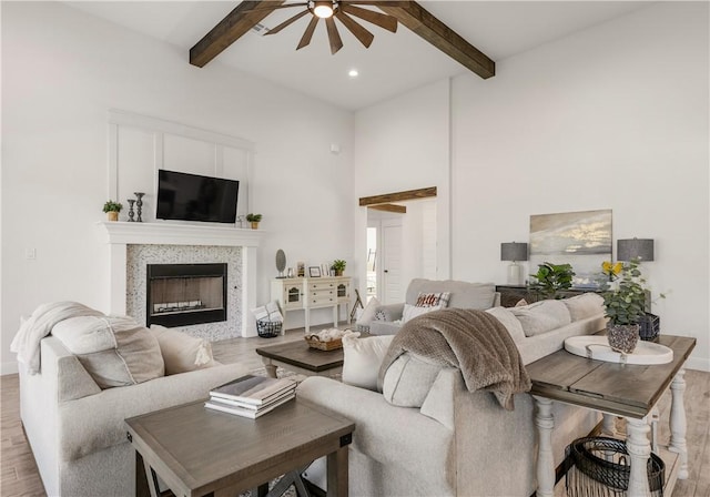 living room with beamed ceiling and light hardwood / wood-style flooring