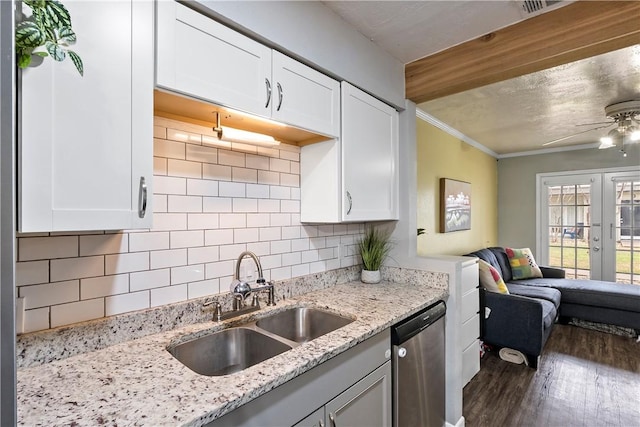 kitchen with a sink, white cabinetry, open floor plan, french doors, and dishwasher