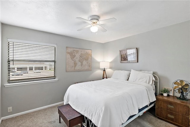 bedroom with carpet, baseboards, and ceiling fan