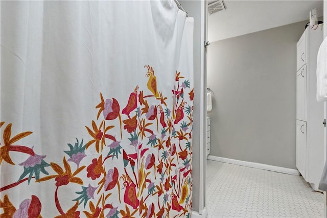 bathroom featuring baseboards and visible vents