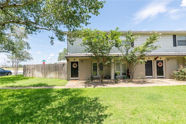 view of front of home featuring french doors, a front lawn, and fence