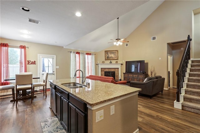 13423 Ashley Acres Ln, Cypress, TX 77429 - kitchen with a sink, dark wood-type flooring, a fireplace, a ceiling fan, and vaulted ceiling
