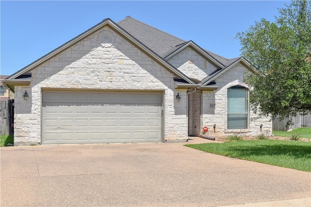 3310 Keefer Loop, College Station, TX 77845 - view of front of home with stone siding, driveway, and a garage
