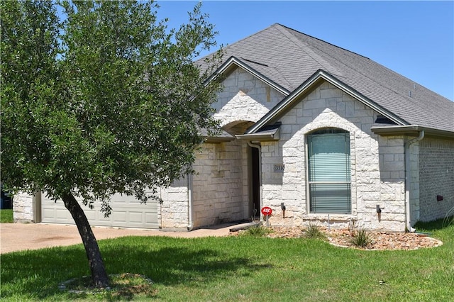 3310 Keefer Loop, College Station, TX 77845 - french country style house with stone siding, an attached garage, roof with shingles, and a front yard