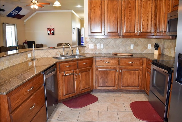 3310 Keefer Loop, College Station, TX 77845 - kitchen with stainless steel appliances, ornamental molding, a sink, ceiling fan, and stone counters