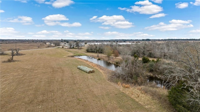 drone / aerial view featuring a water view and a rural view