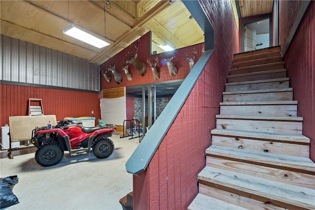 staircase featuring concrete floors