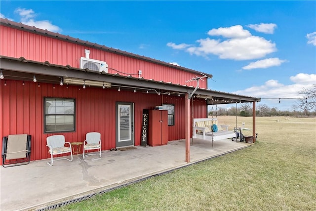 rear view of property featuring a patio and a yard