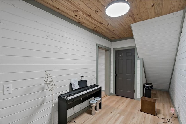 miscellaneous room with wooden ceiling, light hardwood / wood-style flooring, and wooden walls