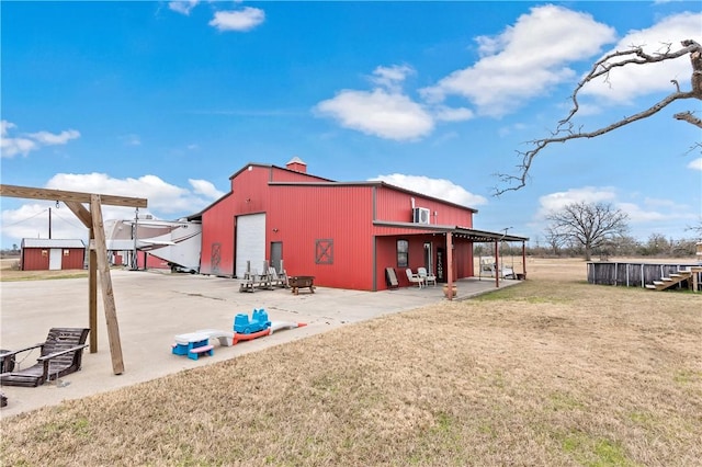 view of outbuilding with a garage and a yard