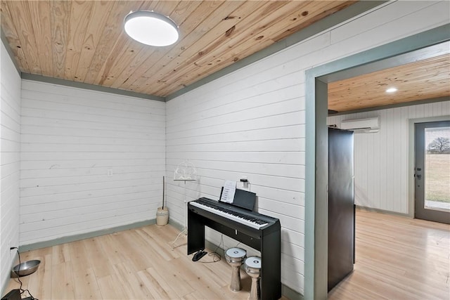 misc room with wood ceiling, wood walls, light hardwood / wood-style floors, and a wall unit AC