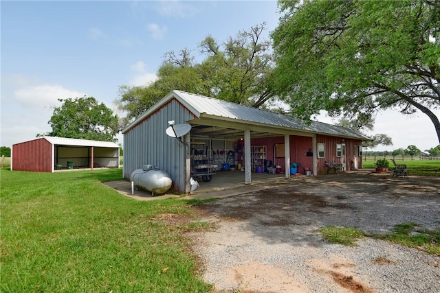 view of outbuilding featuring a yard