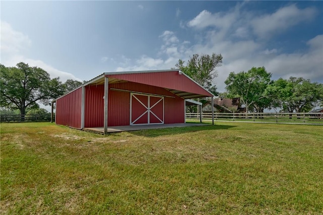 view of outbuilding with a yard