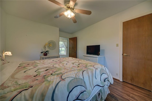 bedroom featuring lofted ceiling, ceiling fan, and dark hardwood / wood-style flooring