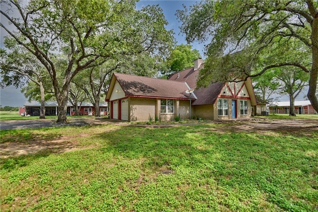 exterior space with a garage and a yard