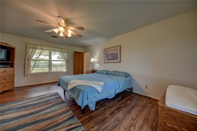 bedroom featuring ceiling fan and dark wood-type flooring