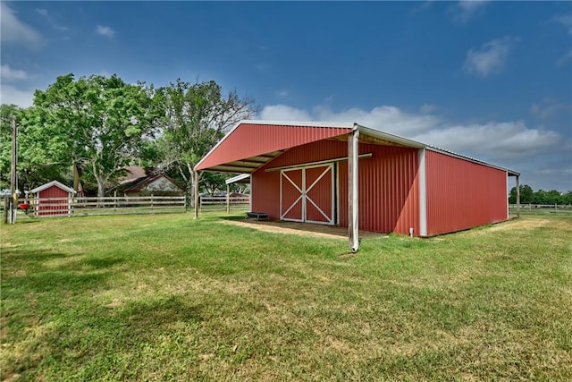 view of outbuilding with a yard