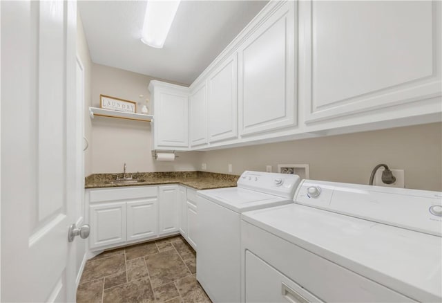 6997 Shirley Rd, Bryan, TX 77808 - laundry area featuring washing machine and dryer, cabinet space, and stone finish floors