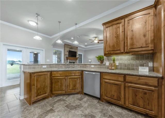 6997 Shirley Rd, Bryan, TX 77808 - kitchen featuring stainless steel dishwasher, brown cabinets, ceiling fan, ornamental molding, and healthy amount of natural light