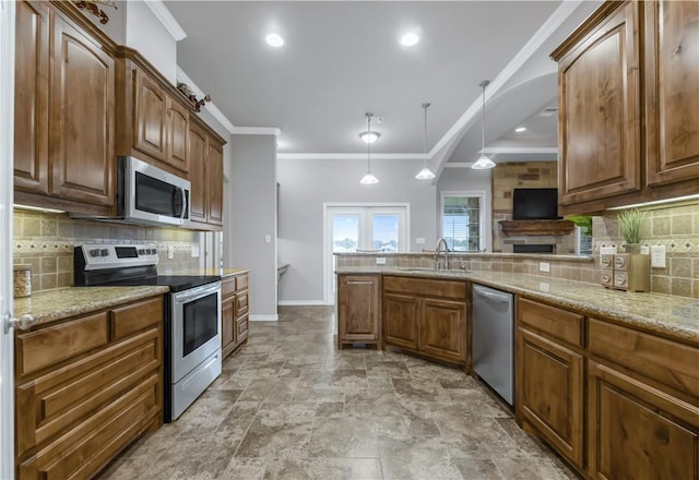 6997 Shirley Rd, Bryan, TX 77808 - kitchen featuring appliances with stainless steel finishes, light stone countertops, backsplash, crown molding, and hanging light fixtures