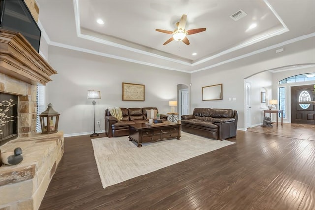 6997 Shirley Rd, Bryan, TX 77808 - living room with arched walkways, a tray ceiling, ornamental molding, and recessed lighting