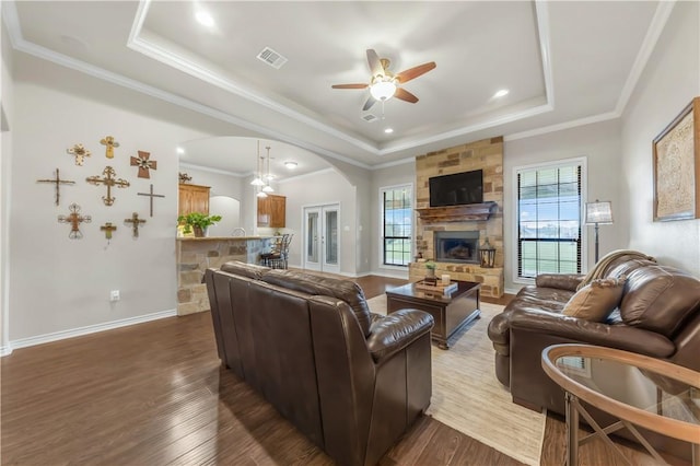 6997 Shirley Rd, Bryan, TX 77808 - living area with a raised ceiling, arched walkways, ceiling fan, dark wood-style floors, and ornamental molding