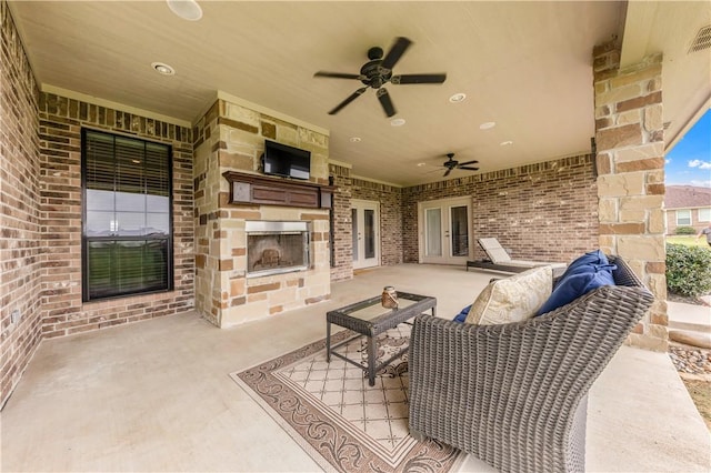 6997 Shirley Rd, Bryan, TX 77808 - view of patio / terrace featuring french doors, an outdoor stone fireplace, and a ceiling fan