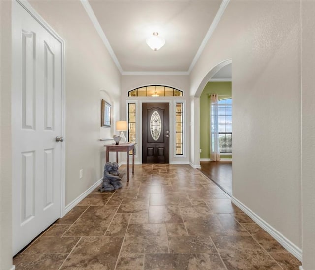 6997 Shirley Rd, Bryan, TX 77808 - entrance foyer featuring arched walkways, stone tile flooring, and crown molding