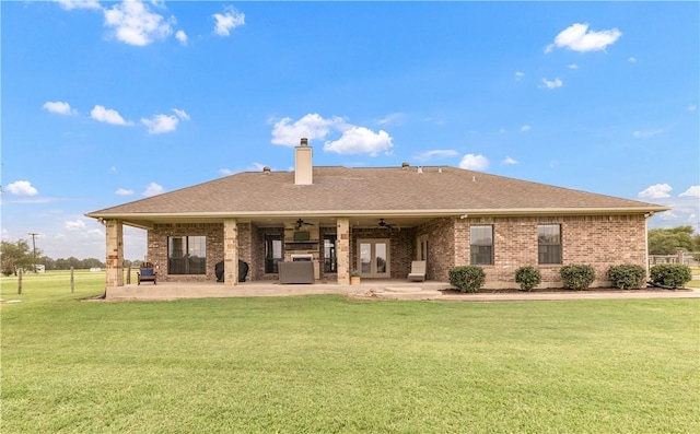 6997 Shirley Rd, Bryan, TX 77808 - rear view of house with a ceiling fan, a patio, a lawn, a chimney, and brick siding
