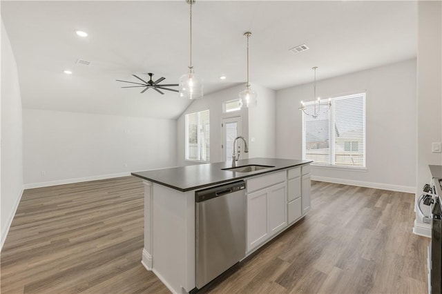 kitchen featuring visible vents, a sink, stainless steel appliances, white cabinetry, and dark countertops