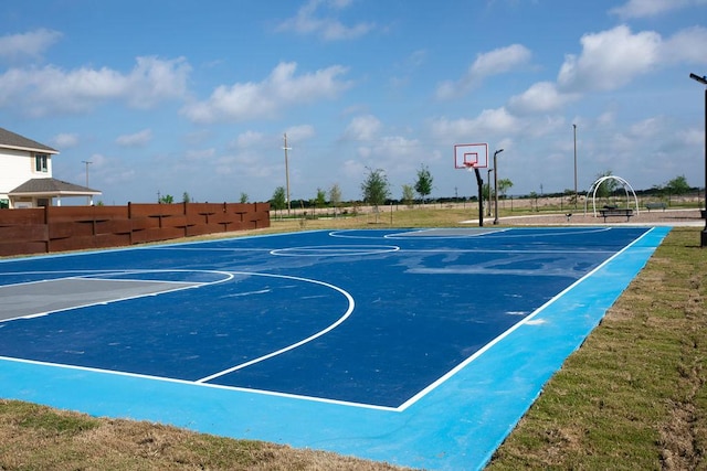 view of basketball court with community basketball court and fence