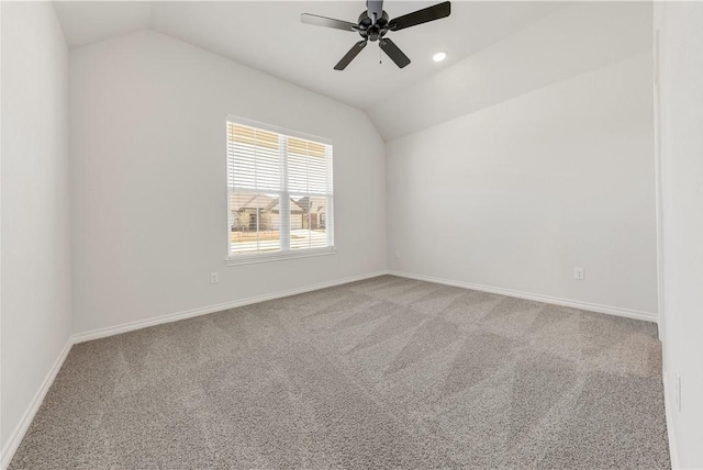 spare room featuring baseboards, lofted ceiling, and carpet floors