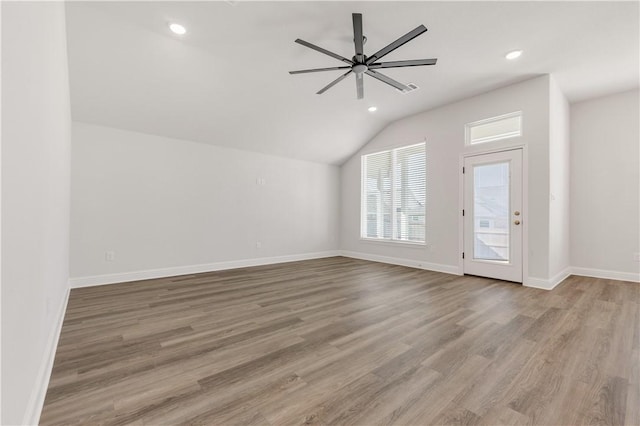 unfurnished living room featuring light wood-type flooring, recessed lighting, baseboards, lofted ceiling, and ceiling fan