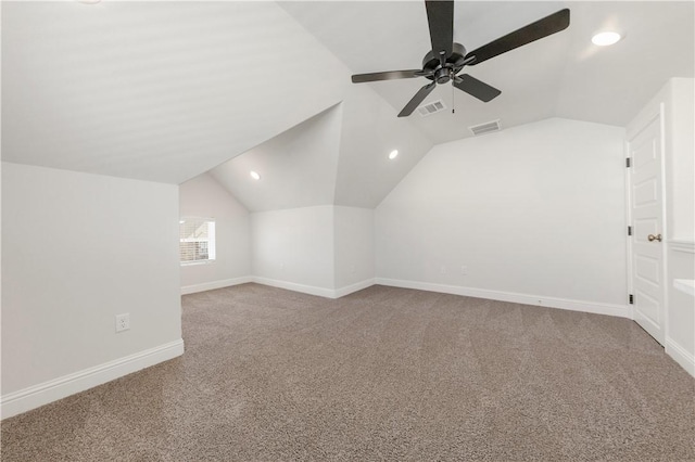 additional living space with lofted ceiling, baseboards, visible vents, and carpet floors