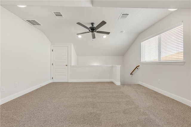 bonus room featuring lofted ceiling, carpet, and visible vents