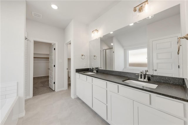 full bathroom with a sink, visible vents, a bath, and a shower stall