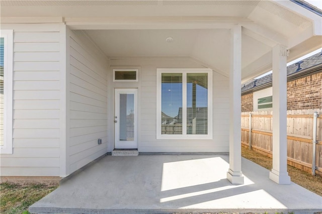 doorway to property with a patio area and fence