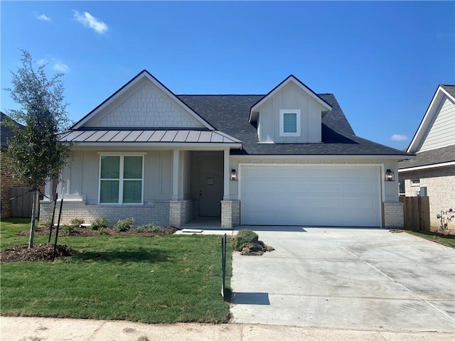 view of front of property with a front lawn and a garage